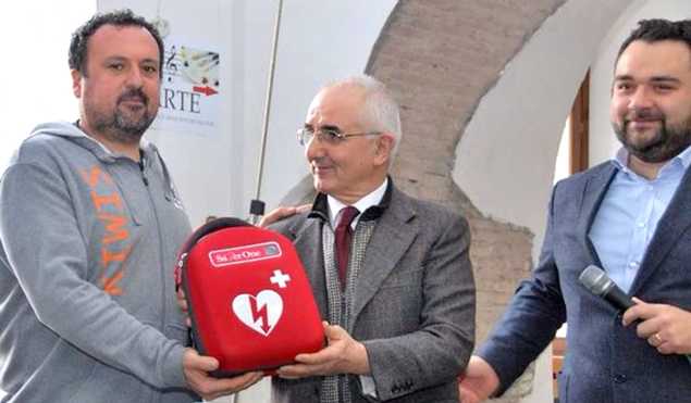 Al centro Renzo Calzati consegna il defibrillatore donato